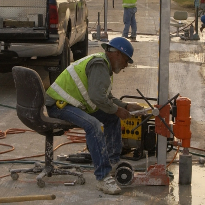 Worker drilling a core in concrete